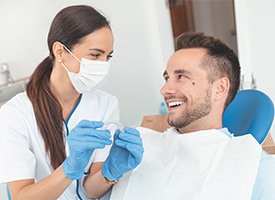 A dentist giving a patient their Invisalign aligners