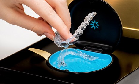 An Invisalign welcome kit with a case and aligners